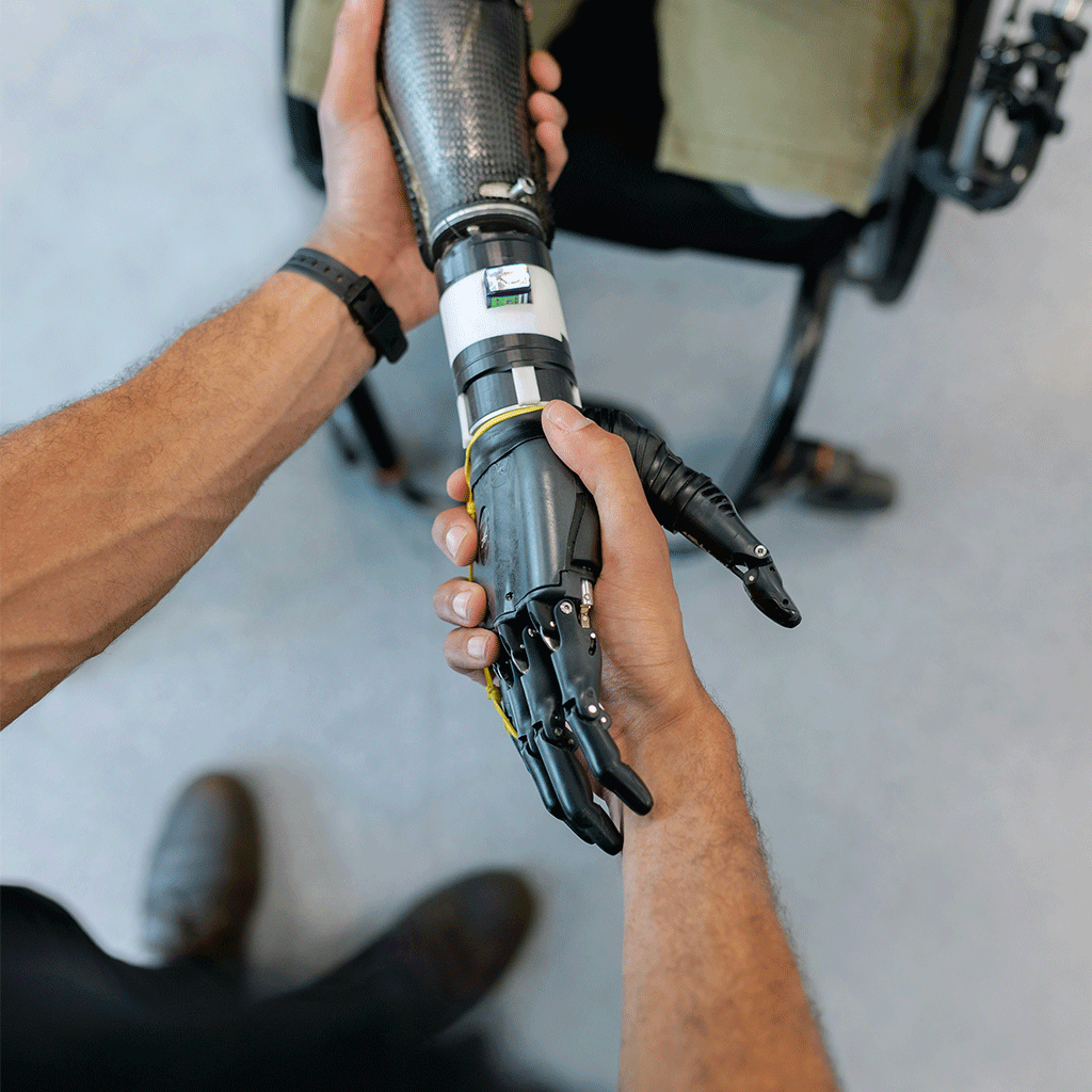 MyoPro Upper Limb Rehabilitation – Exceptional Personalization Shaking MyoPro Hand Patient greeting another person while wearing a MyoPro orthosis